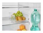 Fresh grapes, kiwis, oranges, and lemons in clear containers inside a refrigerator.