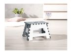 A foldable plastic step stool in white and dark gray sits on a light wood floor.