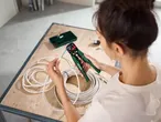 A person using Parkside wire strippers on electrical cables.