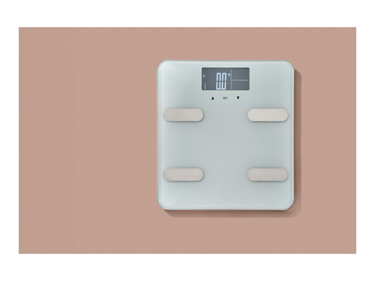 Digital bathroom scale with a light blue surface and silver electrodes, displaying '0.0 kg'