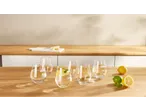 Glasses of water with lemon and lime on a wooden kitchen counter.