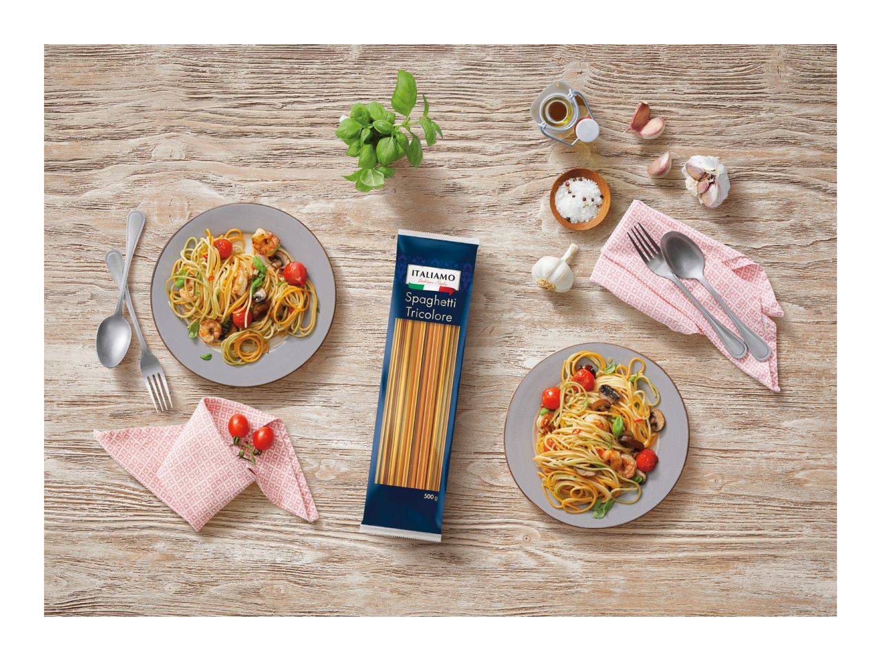 Tricolore spaghetti with shrimp, tomatoes, and mushrooms, served on a rustic wooden table.
