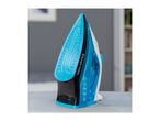 A blue and black Russell Hobbs iron standing upright on an ironing board.