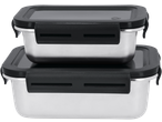 Two stainless steel food containers with black lids and clasps, stacked on a black background.