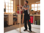 Man in Parkside overalls marking wood in a workshop.