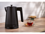 SILVERCREST® 3000W Kettle in black, with tea and cookies on a wooden counter.