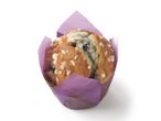 Blueberry muffin with sugar topping in purple liner.