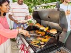Grilling burgers, chicken, and vegetables outdoors.