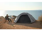 CRIVIT 4 Person Blackout Tent and camping gear by the sea with a person.