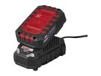 A black and red power tool battery charging on a black charger, with a power cord.