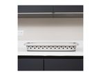 A grey and white laundry basket sits on a white countertop between dark grey cabinets.