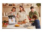 A family cooking together in a kitchen with a white cooking machine.