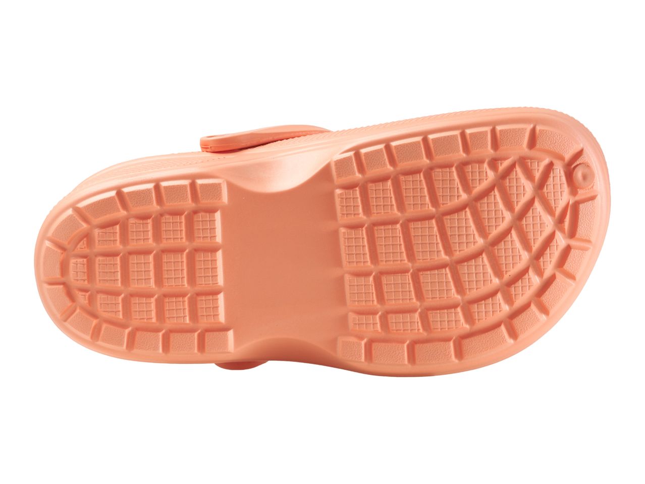 Bottom view of a single peach-colored children's clog with a textured sole.