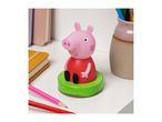 Peppa Pig pencil sharpener on a white shelf with notebooks and colored pencils.