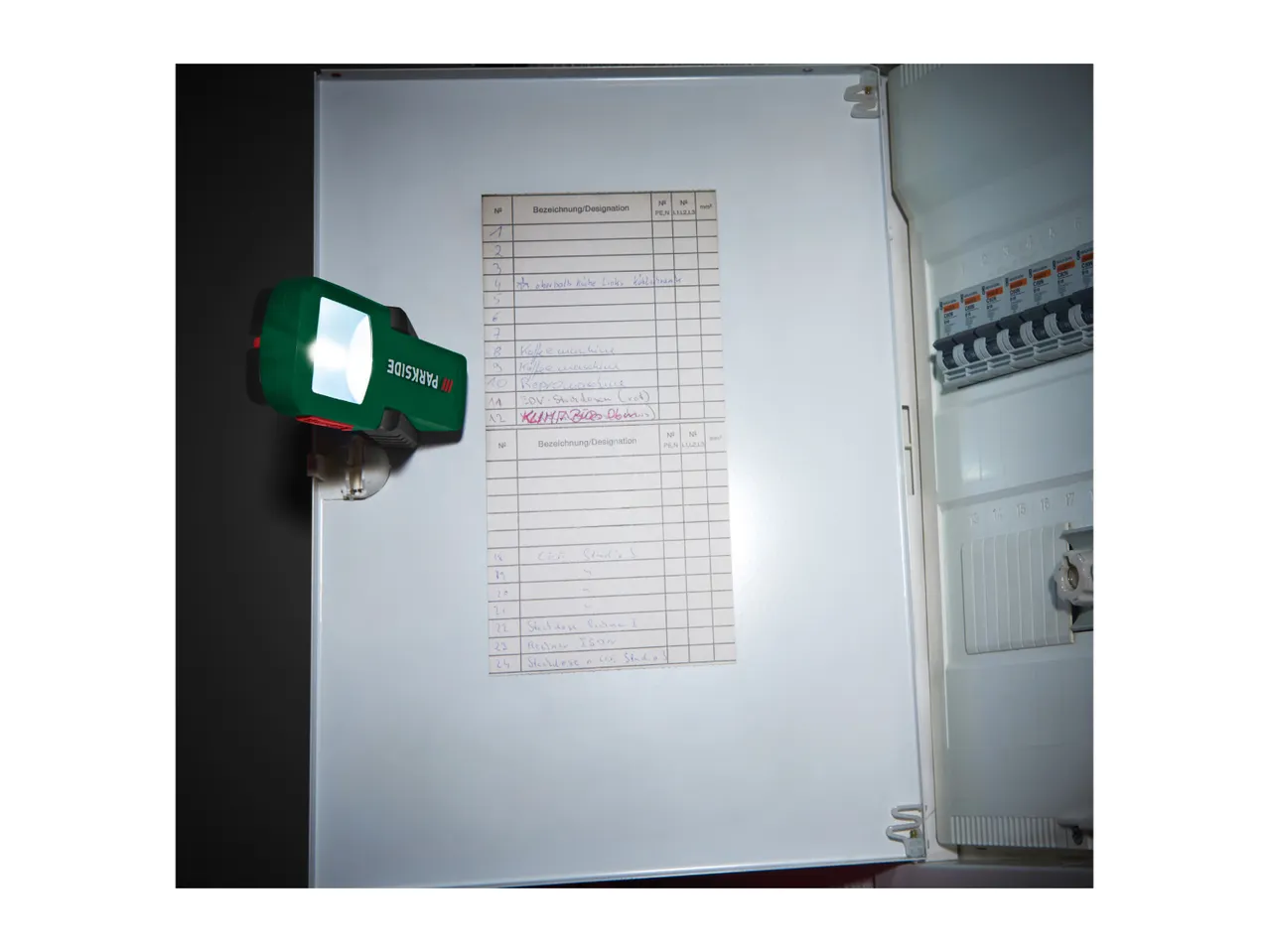 PARKSIDE LED work light illuminating a fuse box with a circuit diagram.
