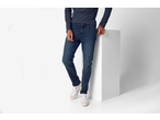 Man wearing esmara® Men's Slim Fit Jeans, a dark blue long-sleeve shirt, and white sneakers.