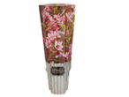 Weigela 'Nana Purpurea' plant in a decorative sleeve with pink flowers and a wooden texture.