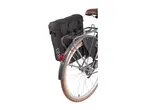 Rear view of a bicycle with black pannier bags and a brown saddle.