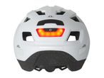 Rear view of a white bicycle helmet with a red LED light and power button.