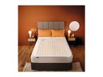 Heated underblanket on a double bed in a modern bedroom with warm lighting.