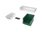 Assortment of plastic storage bins in white and green, including a divider.