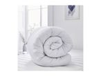 Rolled white duvet on a mattress in a bright room.