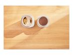 Two containers on a wooden table, one with granola and the other with chocolate drops.