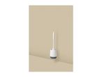 White toilet brush with a grey base in a modern bathroom setting.