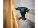 A person uses a Parkside X20V Team cordless Impact Driver to screw into wood.