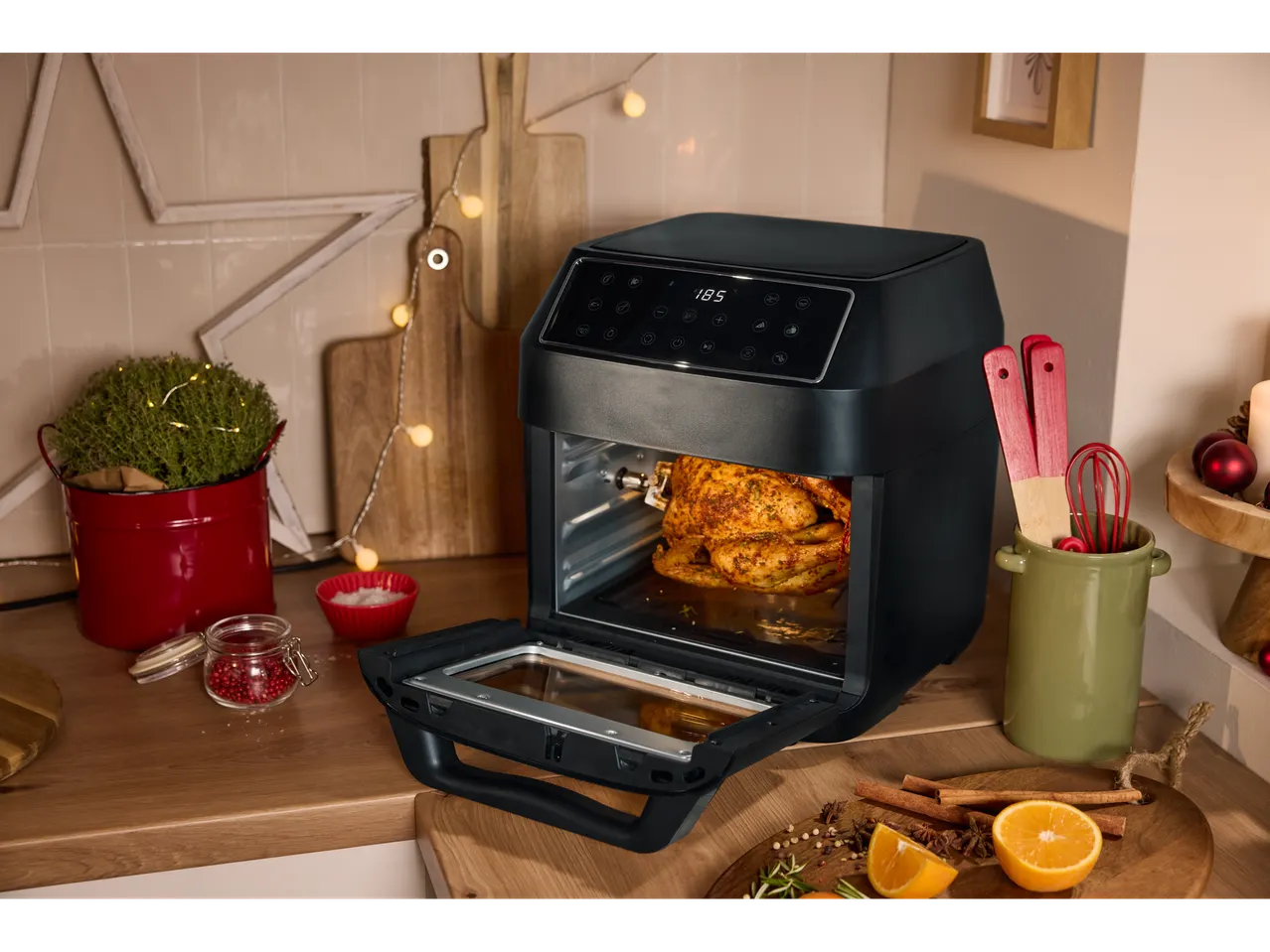 Silvercrest® Kitchen Tools 9-in-1 Air Fryer with a whole chicken inside, surrounded by kitchen tools.