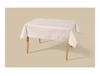 Rectangular table with a light-colored tablecloth featuring a subtle geometric pattern.