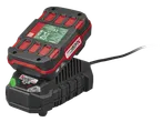 A power tool battery charging on a charger, with a green indicator light.