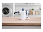 White and blue handheld steam cleaner on a wooden countertop in a laundry room.