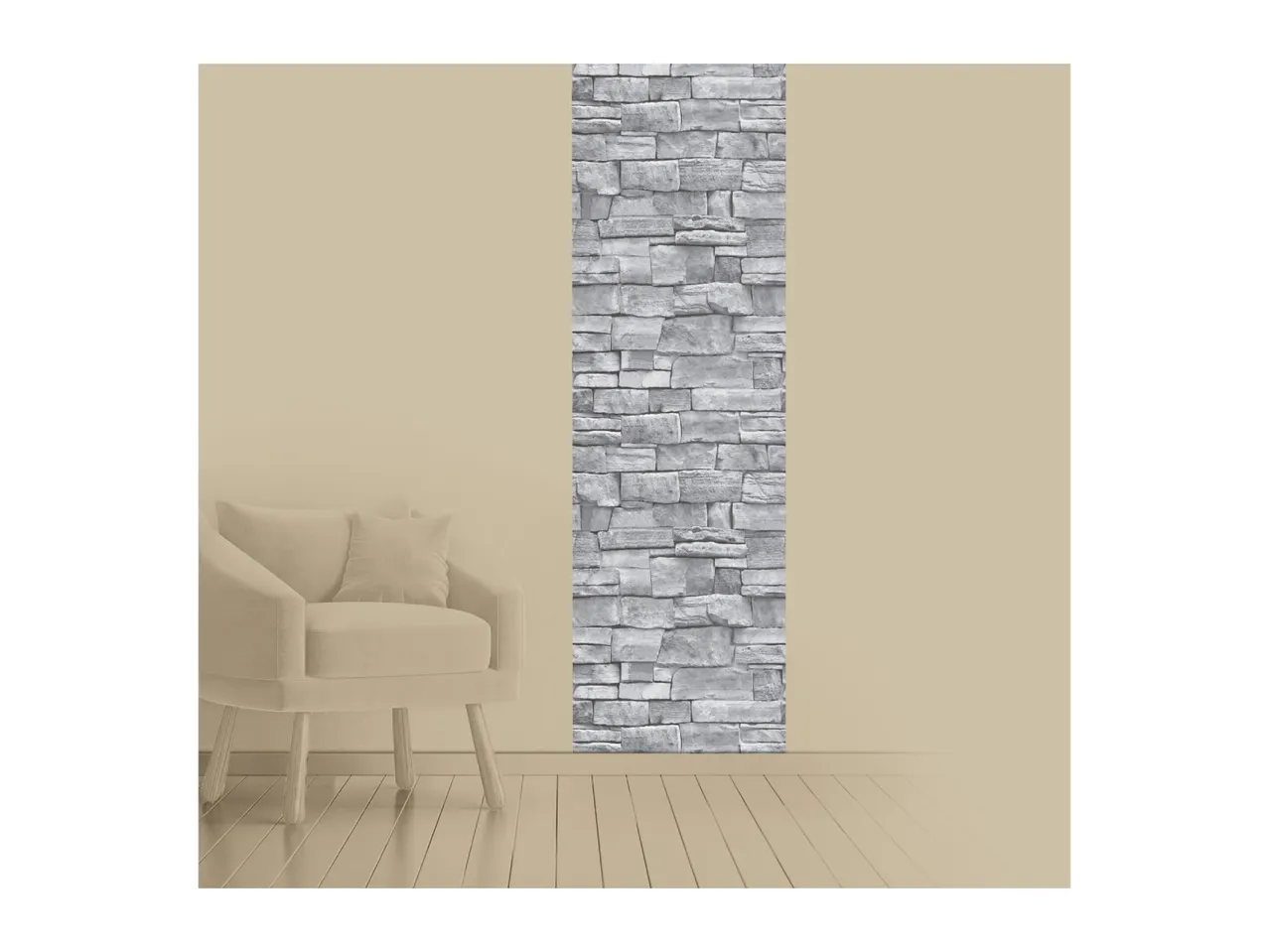 Beige armchair with a cushion next to a wall with a vertical grey stone pattern.