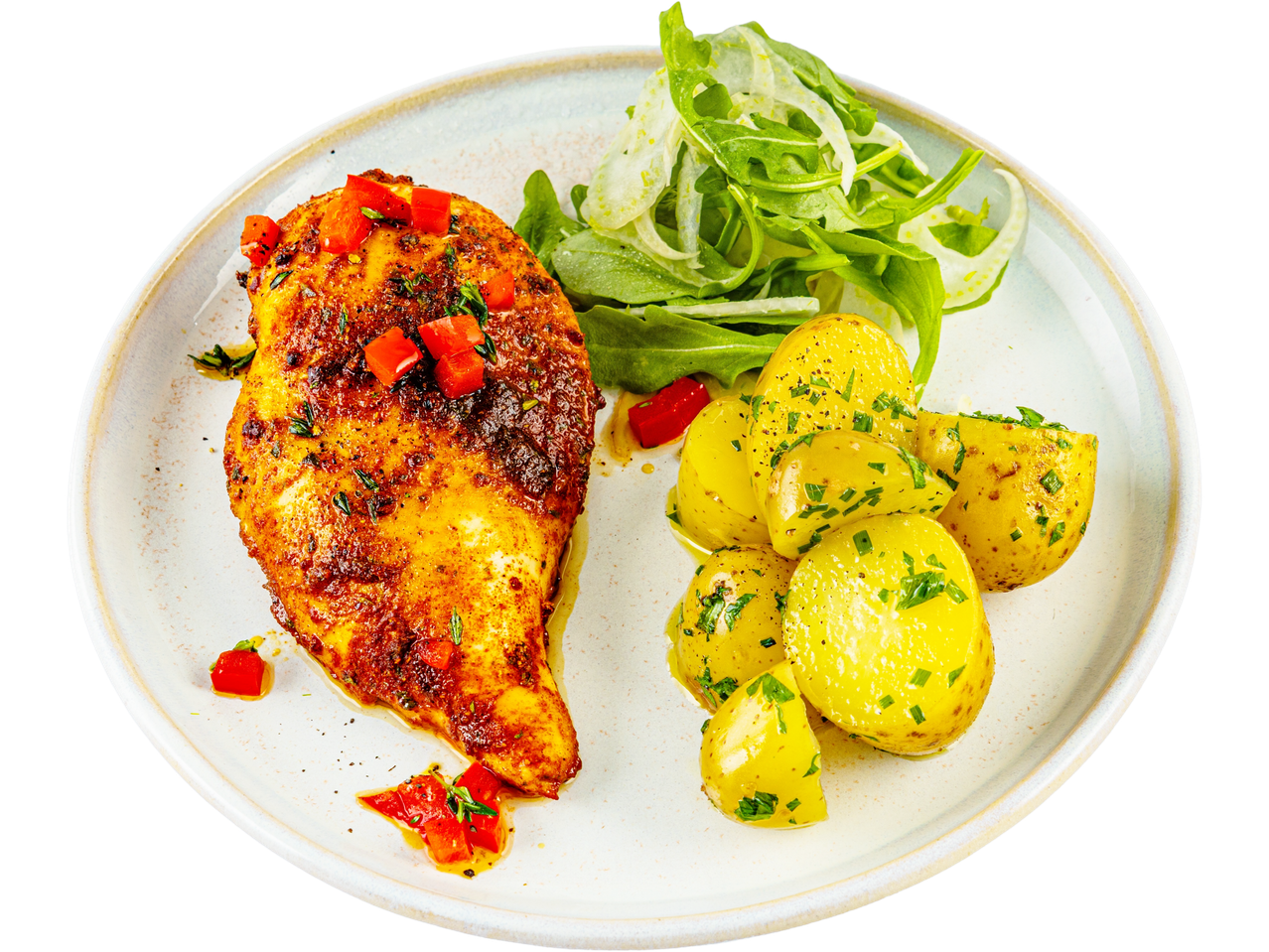 Spicy chicken breast with baby potatoes and a fresh rocket salad on a white plate.