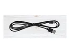 Black USB to micro-USB cable, neatly coiled on a light wooden surface.