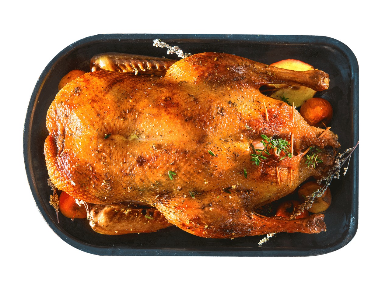 Röstitud part õunte ja ürtidega mustal ahjuplaadil.