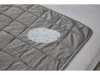 Gray quilted blanket with a section showing glass bead filling.