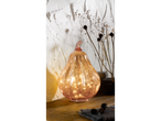 LIVARNO home Light-Up Decorative Pumpkin on a wooden surface with dried plants.