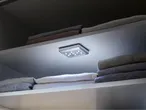 LED closet lighting and neatly folded clothes.