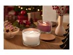 Christmas table setting with two lit candles, cookies, and festive decorations.