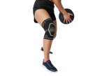 Woman wearing Crivit knee support and holding a medicine ball.