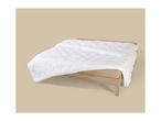 White quilted duvet on a light wooden bed frame with a beige fitted sheet.