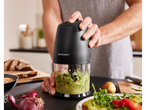 A person uses a SilverCrest mini chopper to make guacamole.