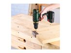 A person using a cordless drill to attach a metal hinge to a wooden surface.
