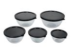 Set of five clear plastic food storage bowls with black lids, arranged on a white background.