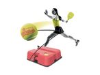 A woman playing with a tennis trainer, featuring a tennis ball on a string attached to a base.