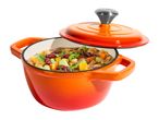 Orange cast iron pot with lid, filled with a hearty stew of meat, beans, and vegetables.