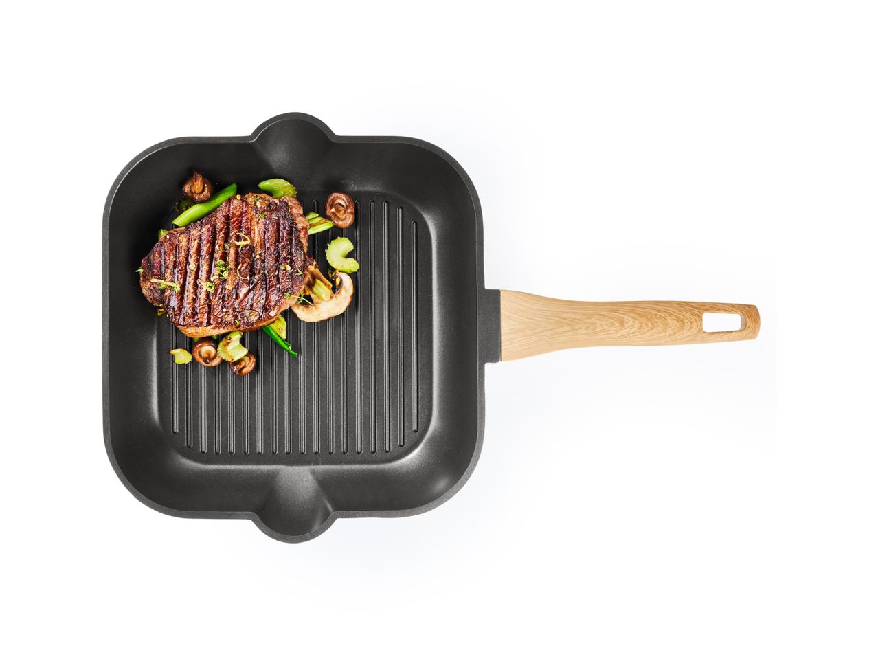 Grilled steak and vegetables in a grill pan.