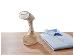 SILVERCREST® Garment Steamer and a folded blue shirt on a wooden surface.